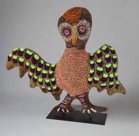 A colourful owl soft sculpture by Rhonda Sharpe with patterned, stitched feathers