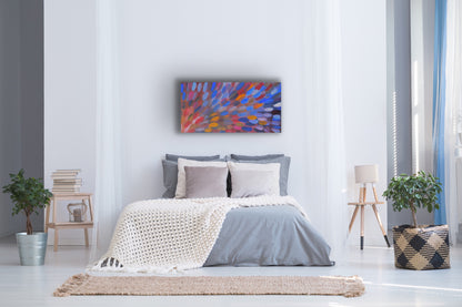 A 120x60cm painting by Gloria Petyarre hanging above a bed in a modern bedroom suite with a bed, abstract plants, side tables and a lamp.