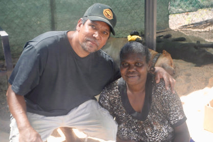 Artists Elah Yunupingu and Barbara Wanambi sitting together.