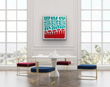 Modern dining room with a white table and colorful chairs, featuring a painting by Aboriginal artist Mitjili Naparrula hanging on the wall.