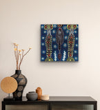 A painting by Colleen Wallace Nungarrayi on a wall above a console table with decorative items.