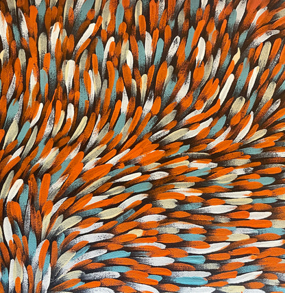 An extreme close-up of a painting by Gloria Petyarre featuring a pattern of Bush Medicine Leaves in orange, light blue and white on a primed linen canvas.