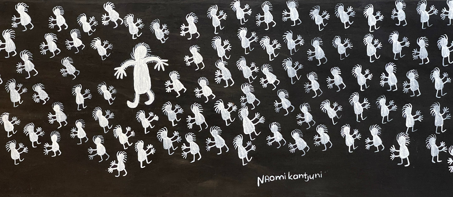 Close-up of a painting on primed linen by Naomi Kantjuriny, featuring a dark background with numerous white figures that represent good and bad spirits.