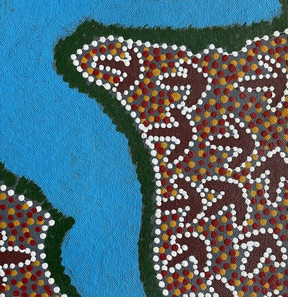 Close-up of a small painting by Lindsay Bird Mpetyane depicting a water hole, a blue shape surrounded by intricate patterned background.