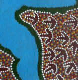 Close-up of a small painting by Lindsay Bird Mpetyane depicting a water hole, a blue shape surrounded by intricate patterned background.