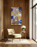 A colourful painting by Marlene Young Nungarrayi on a wooden wall above a beige chair and small table with flowers, 150x90cm.