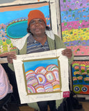 Debbie Beasley holding her 30x30cm bush medicine flowers painting.