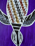 close-up of an artwork by Christine Burarrwanga depicting a sea turtle with traditional rarrk patterns on a purple background.