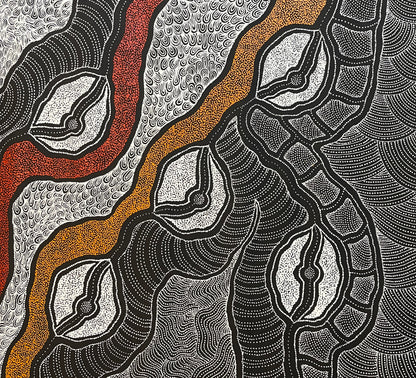 Close-up of a painting by Delvine Pitjara with intricate patterns in red, orange and white dots on black.