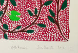 Close-up of a screen print by Jill Daniels 'Wild Banana', artwork depicts leaves and branches on a red and white patterned background
