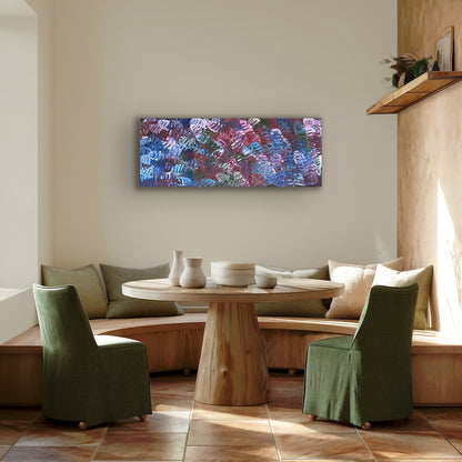 A painting by Emily Pwerle in a modern dining setting with green dining chairs and wooden table.