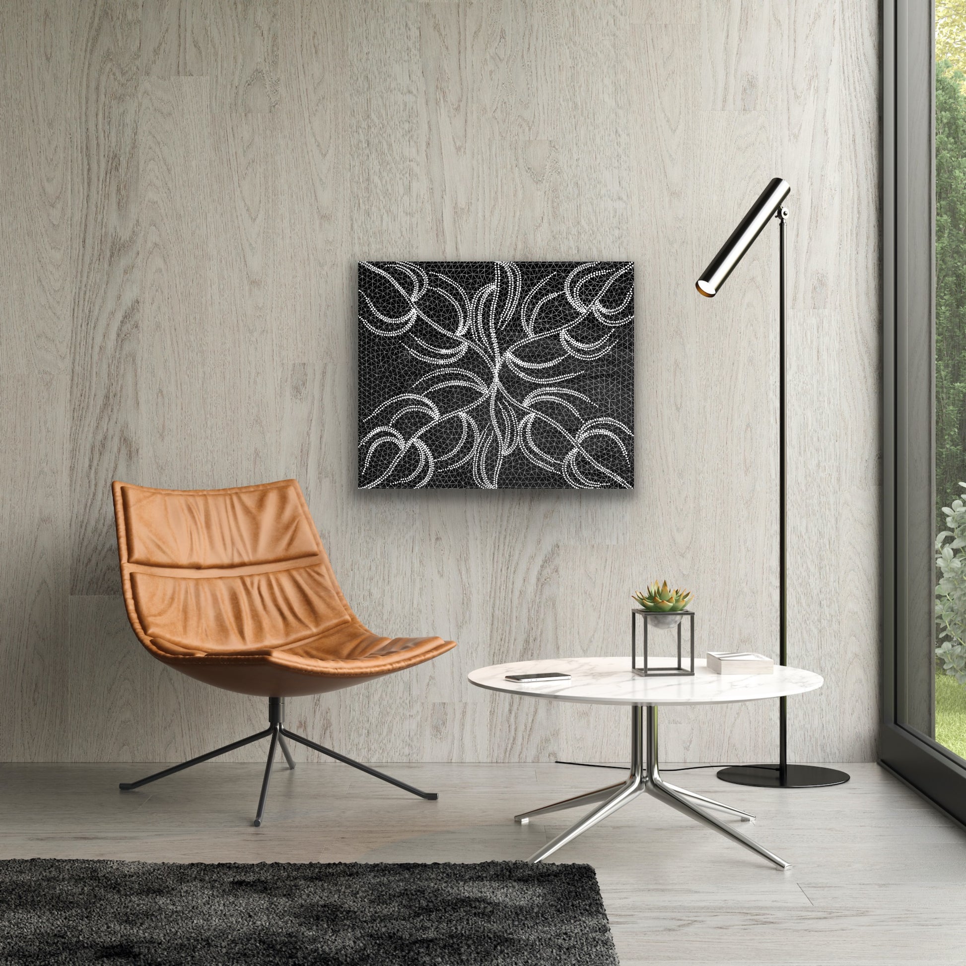 A black and white acrylic painting on canvas by Doreen Dickson Nakamarra depicting her damper seed dreaming, hanging on the wall above a modern brown leather chair, coffee table and lap.