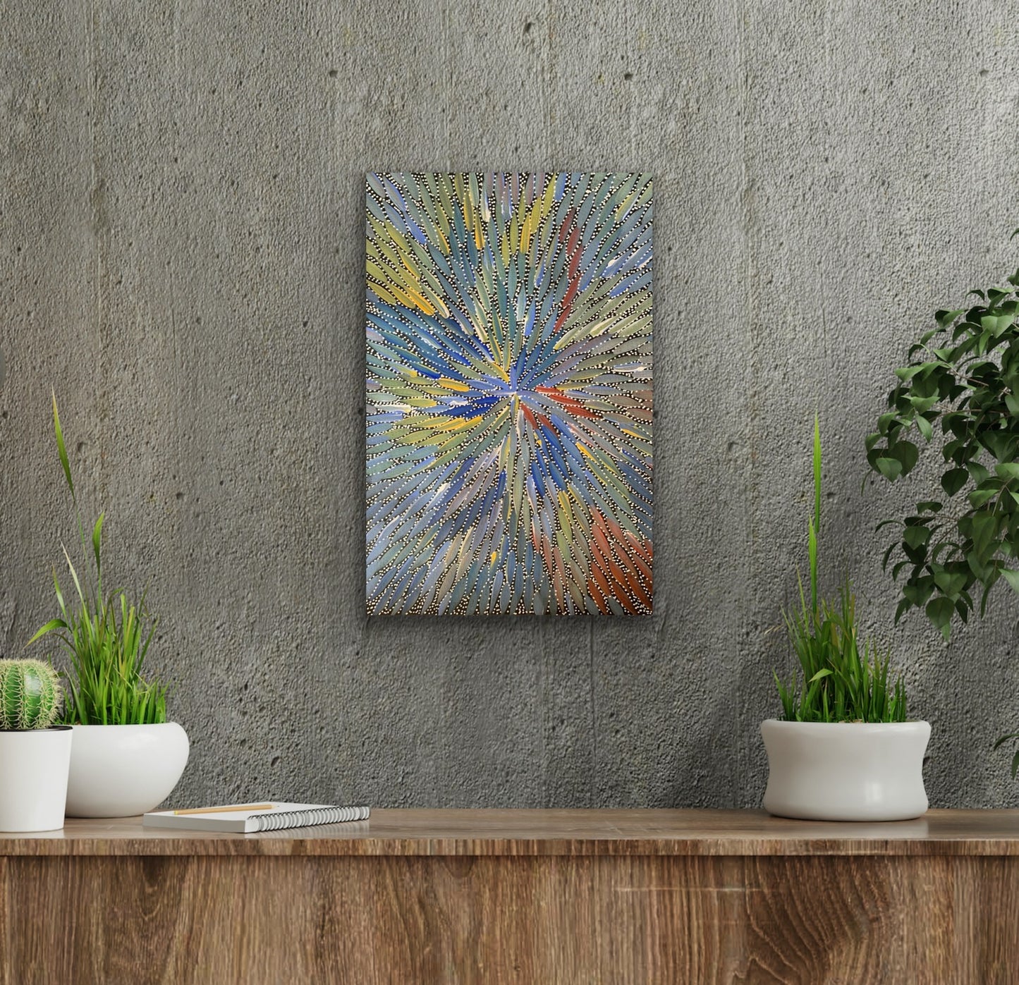 A colourful painting by Bernadine Johnson Kemarre with a radiant pattern in shades of blue, green, yellow, and red, representing Bush Medicine Leaves.