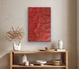 A painting by Bambatu Napangardi hanging on a beige wall above a wooden console table with decorative items.