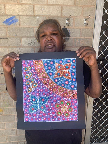 Anna Tilmouth Napangardi holding her 'Atnyerlenge (Native Fuchsia)' painting 36x31cm