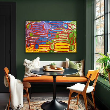 A painting by Lorna Fencer Napurrula depicting yarla or bush potato dreaming on a green wall above a bench with a table and chairs.