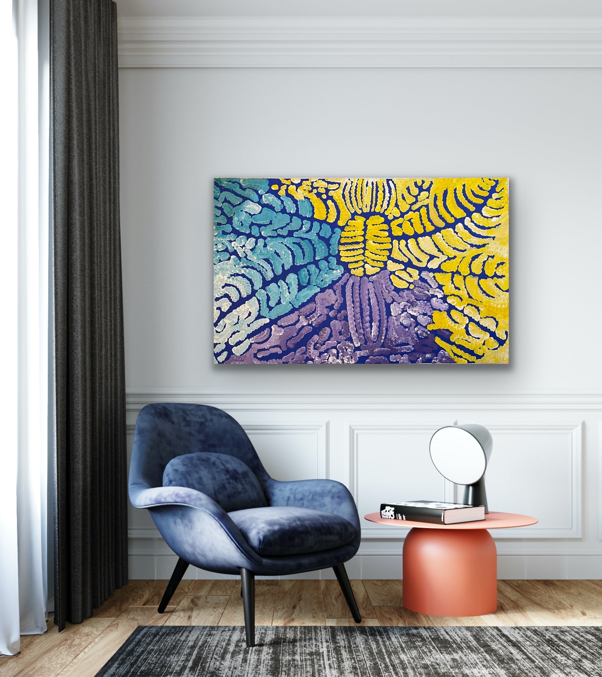 A painting by Lorna Fencer Napurrula depicting yarla or bush potato dreaming hanging in a modern interior with a blue armchair and orange side table.