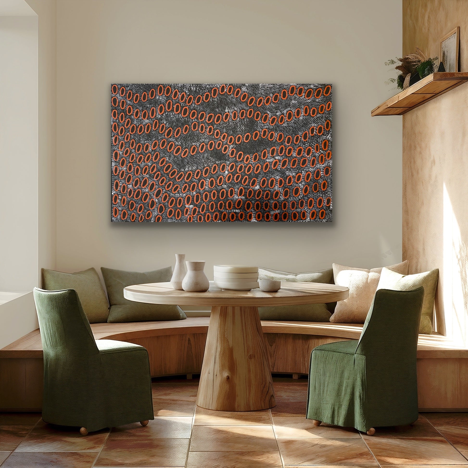 A painting by Ngoia Pollard Napalptjarri hanging in a modern dining room with wooden table, green chairs and pillows.