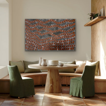 A painting by Ngoia Pollard Napalptjarri hanging in a modern dining room with wooden table, green chairs and pillows.