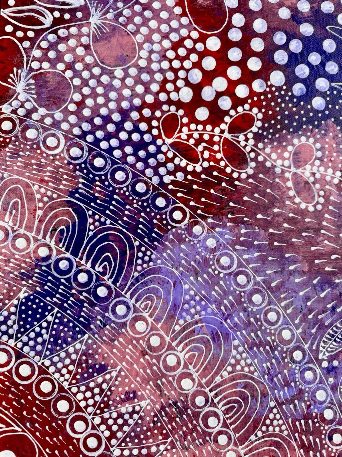 Close-up of a Bush Plum painting by Tanya Bird Mpetyane with dots and lines in white on a red, blue, and purple background.