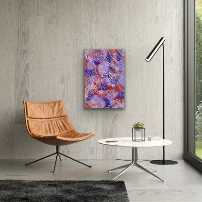 A painting by Tanya Bird Mpetyane hanging on a wood panelled wall. Modern interior with a brown chair, round table.