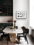 Framed black and white linocut print by Jill Daniels in Dining area with a marble table and black chairs, featuring a framed artwork on the wall.