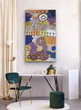 A colourful painting by Marlene Young Nungarrayi on a wall above a modern desk with decor items.