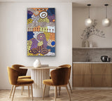 Dining area with an amazing colourful painting by Marlene Young Nungarrayi on the wall, wooden chairs, and a kitchen in the background.