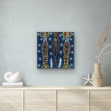 A painting by Colleen Wallace Nungarrayi on a wall above a wooden cabinet.