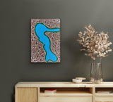 A small painting by Lindsay Bird Mpetyane on a dark wall above a wooden console table.