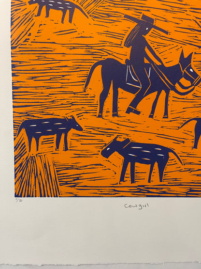 Close-up of an orange and blue lino cut print by Jill Daniels of a cowgirl on horseback mustering cattle.