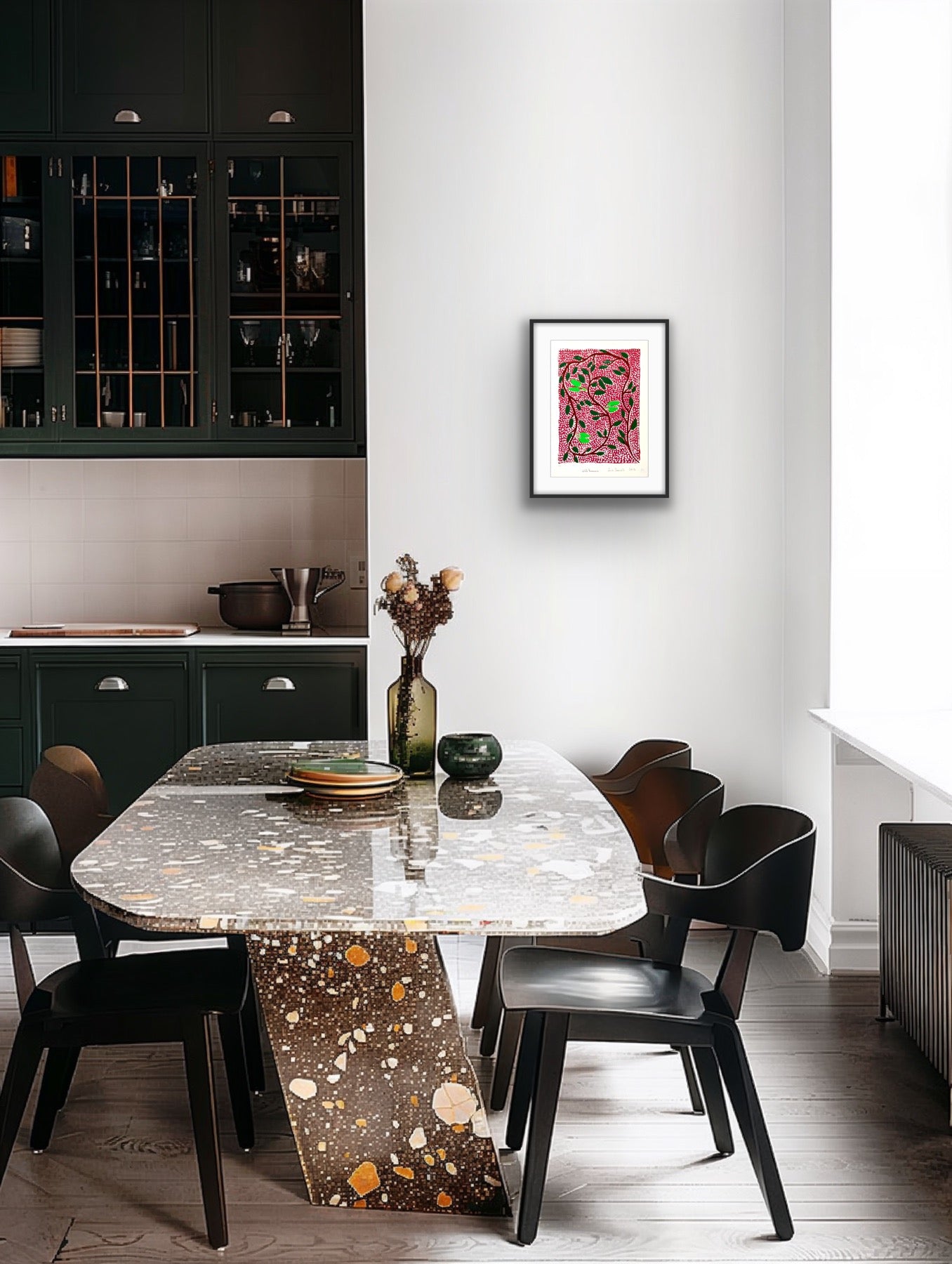 Framed Jill Daniels 'Wild Banana' artwork on a wall above dining area with a marble table and black chairs in a modern kitchen.