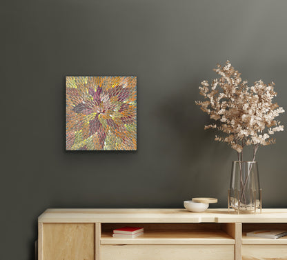 A 30x30cm painting by Bernadine Johnson Kemarre, representing traditional bush medicine plants on a dark wall above a wooden console table with decorative items.