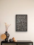 Framed Kenneth Jungarrayi Martin 'Budgerigar Dreaming' artwork on a wall above a console table with decorative items.