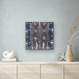 A 45x45cm painting by Colleen Wallace hanging above a wooden cabinet with decorative items.