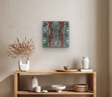 A 45x45cm painting by Colleen Wallace hanging above a wooden console table with various decorative items.
