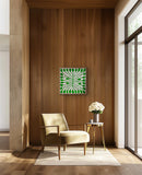 Modern interior with a beige armchair, side table, and decorative wall art by Australian Aboriginal artist Mitjili Naparrula.