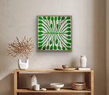 Framed green and white painting by Aboriginal artist Mitjili Naparrula on a wall above a wooden console table with decorative items.