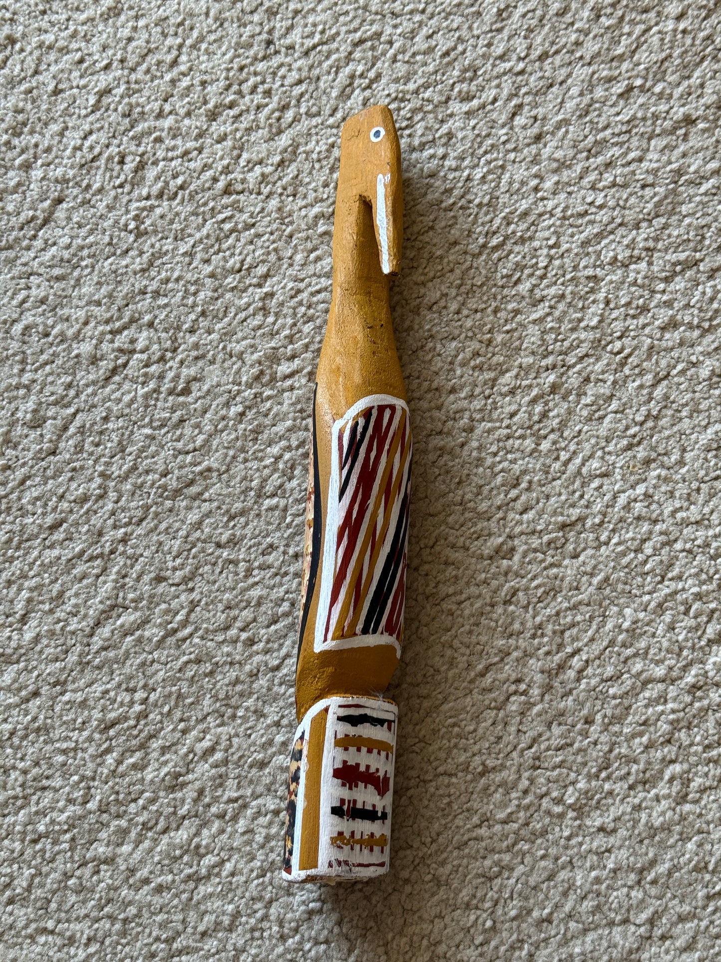 Painted milkwood bird carving by Aboriginal artist Christine Burarrwanga.