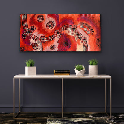 A painting by Teresa Baker featuring abstract geometric patterns with predominantly red and black colors, representing the creation story of Minyma Malilu Tjukurrpa.