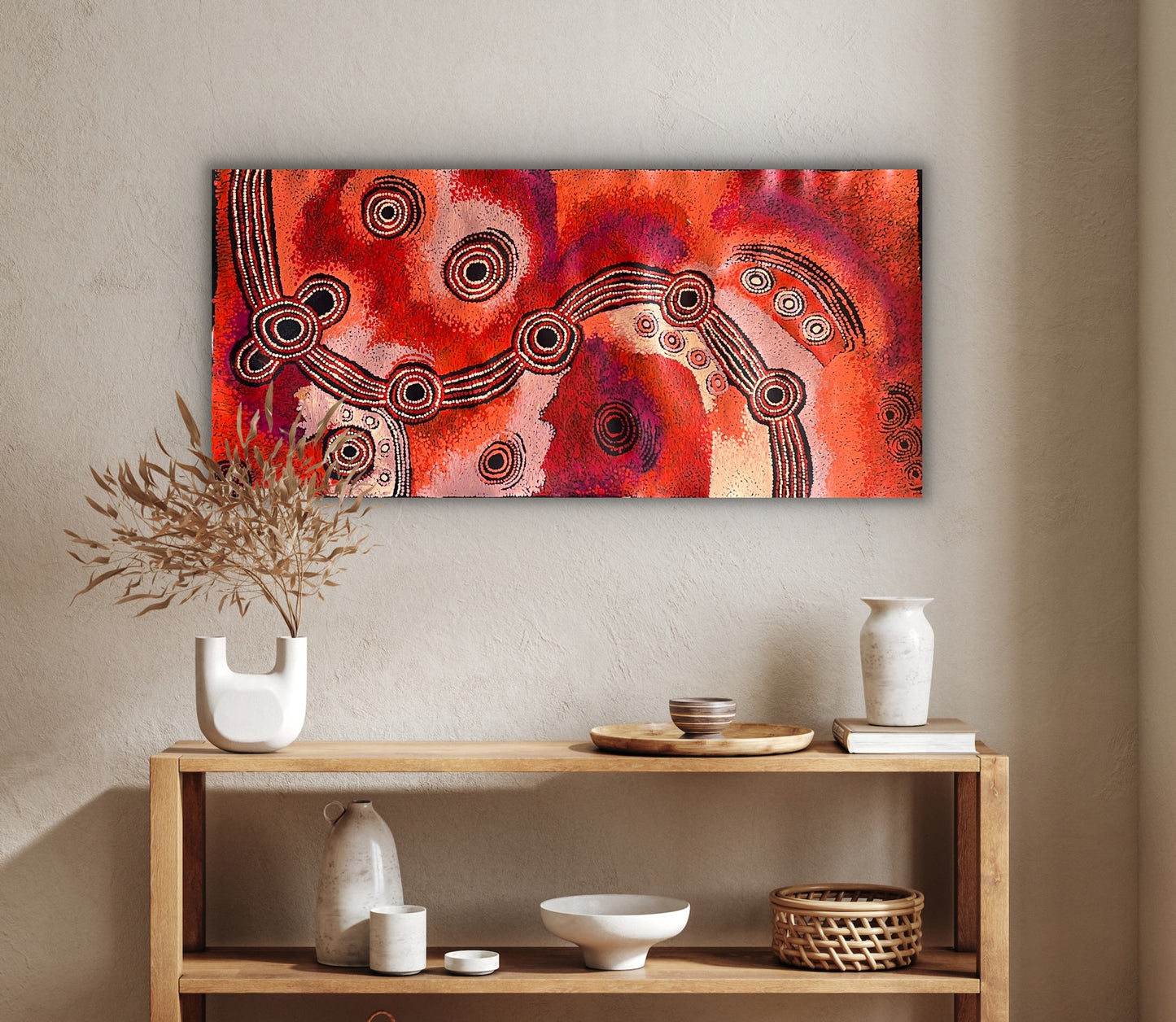 A painting by Teresa Baker featuring abstract geometric patterns with predominantly red and black colors, representing the creation story of Minyma Malilu Tjukurrpa.