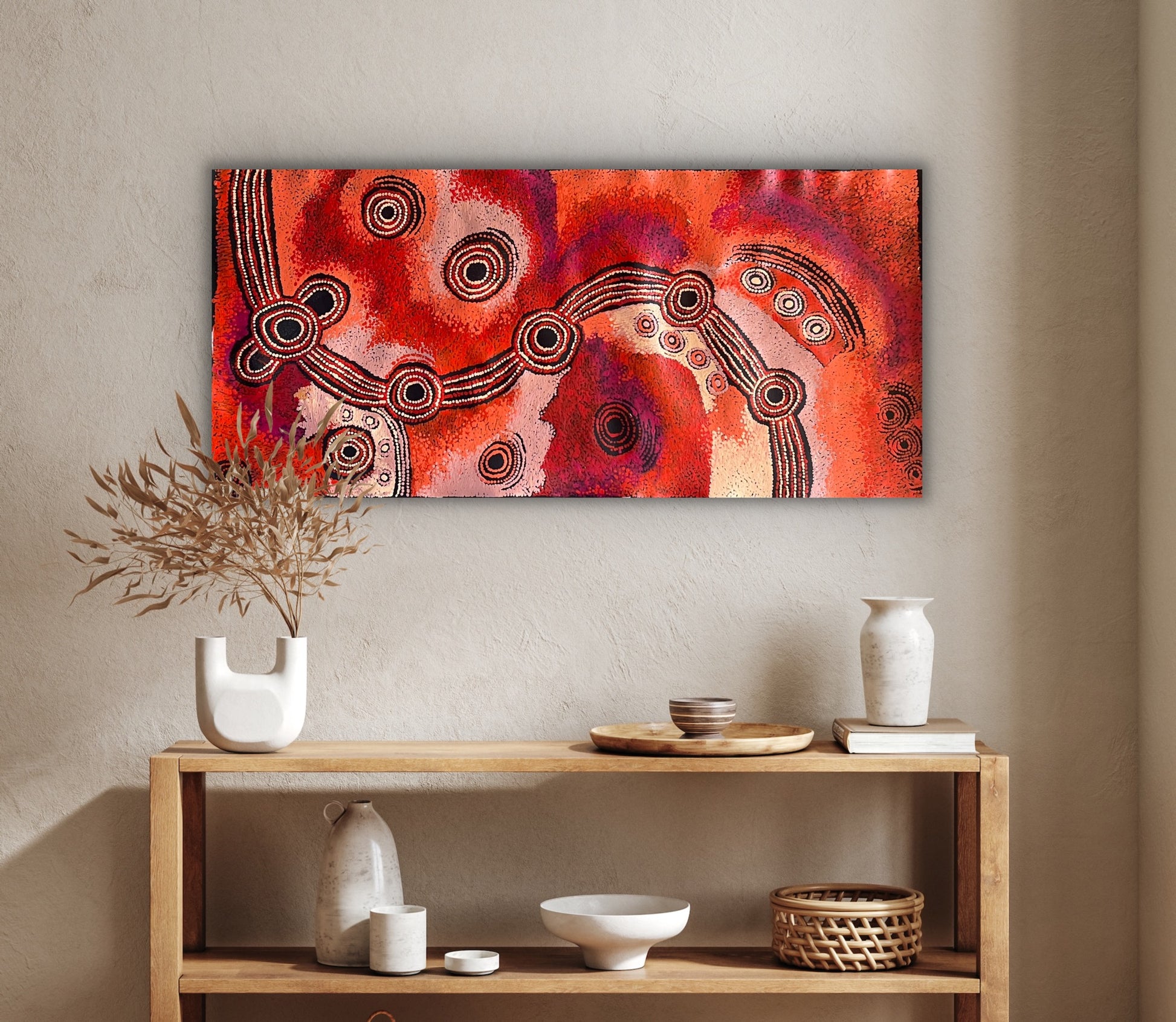 A painting by Teresa Baker featuring abstract geometric patterns with predominantly red and black colors, representing the creation story of Minyma Malilu Tjukurrpa.