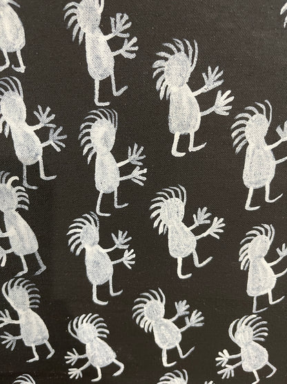Close-up of a painting on primed linen by Naomi Kantjuriny, featuring a dark background with numerous white figures that represent good and bad spirits.