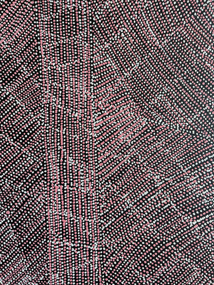 Close-up of a 30x30cm painting by Lizzie Moss Pwerle with a geometric pattern featuring pink and white dots on a black background. 