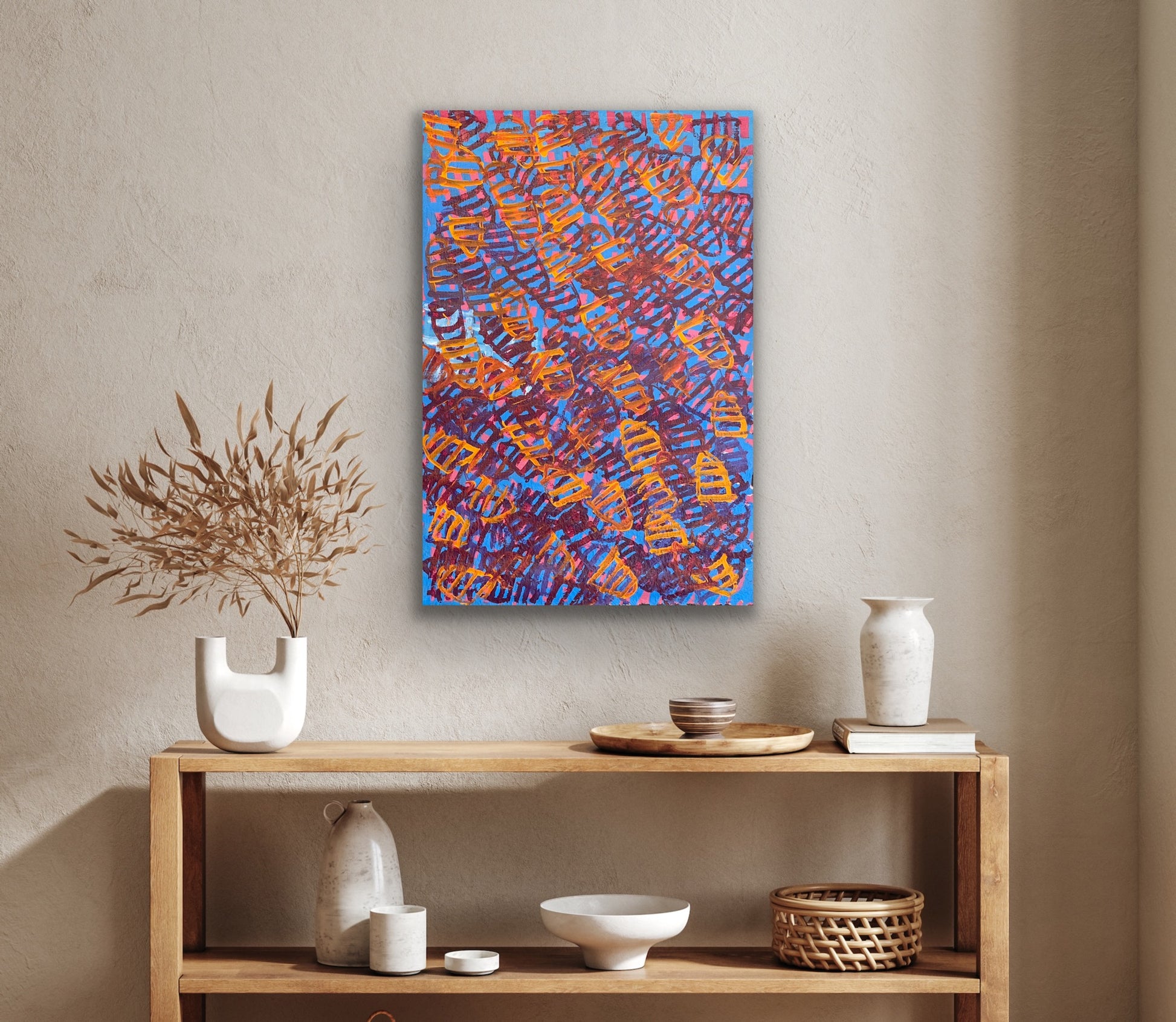 A painting by Emily Pwerle hanging on a textured wall.