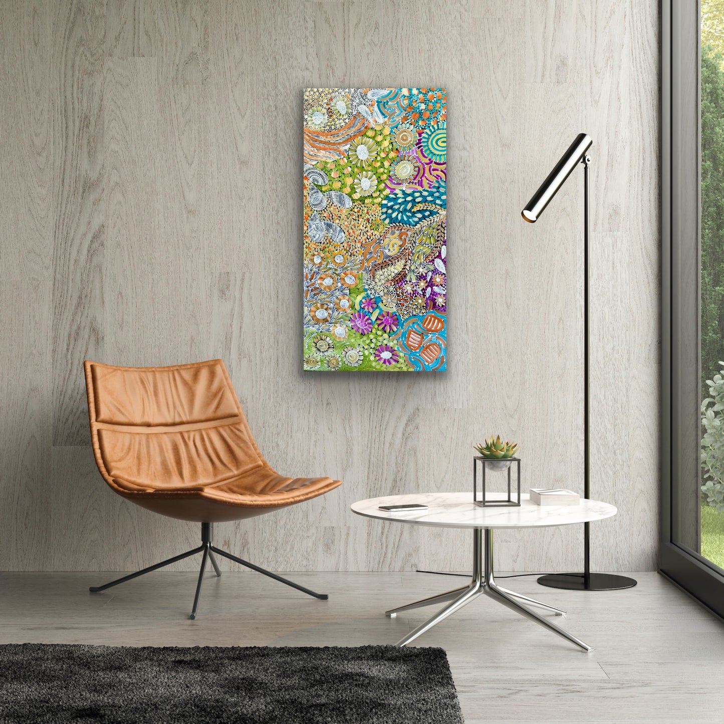 A painting by Karen Bird Ngale in a modern setting with brown chair and marble coffee table.