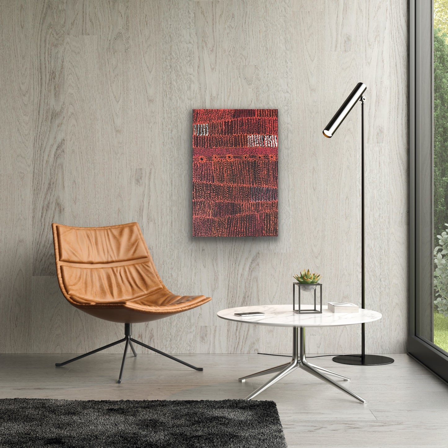 A painting by Maringka Baker in a modern setting with brown chair and marble coffee table.