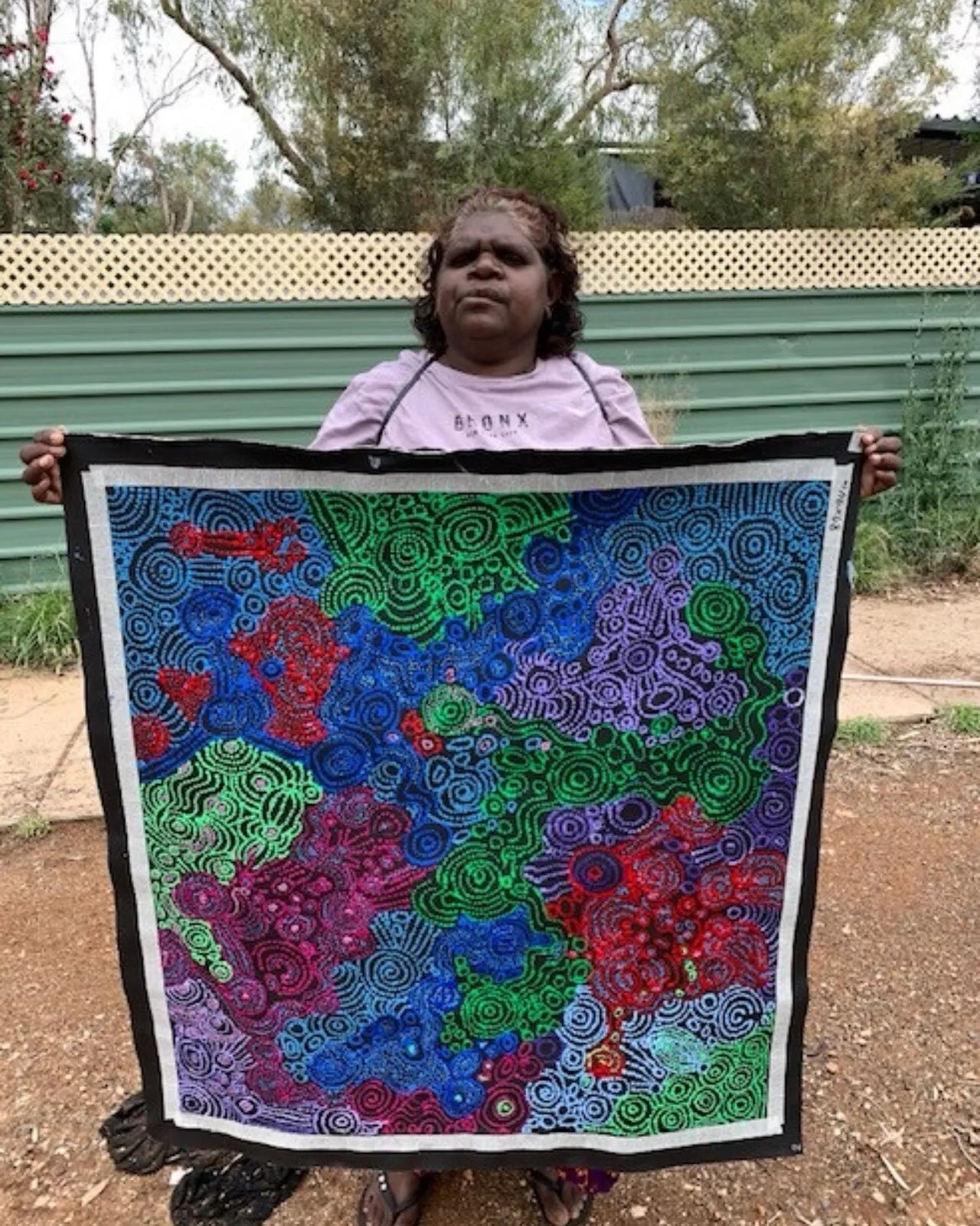 Meredith Curley holding her painting.