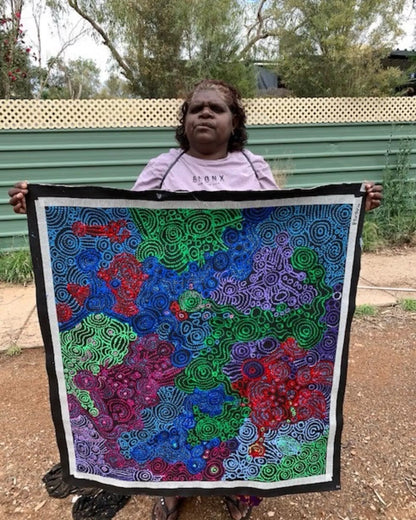 Meredith Curley holding her painting.