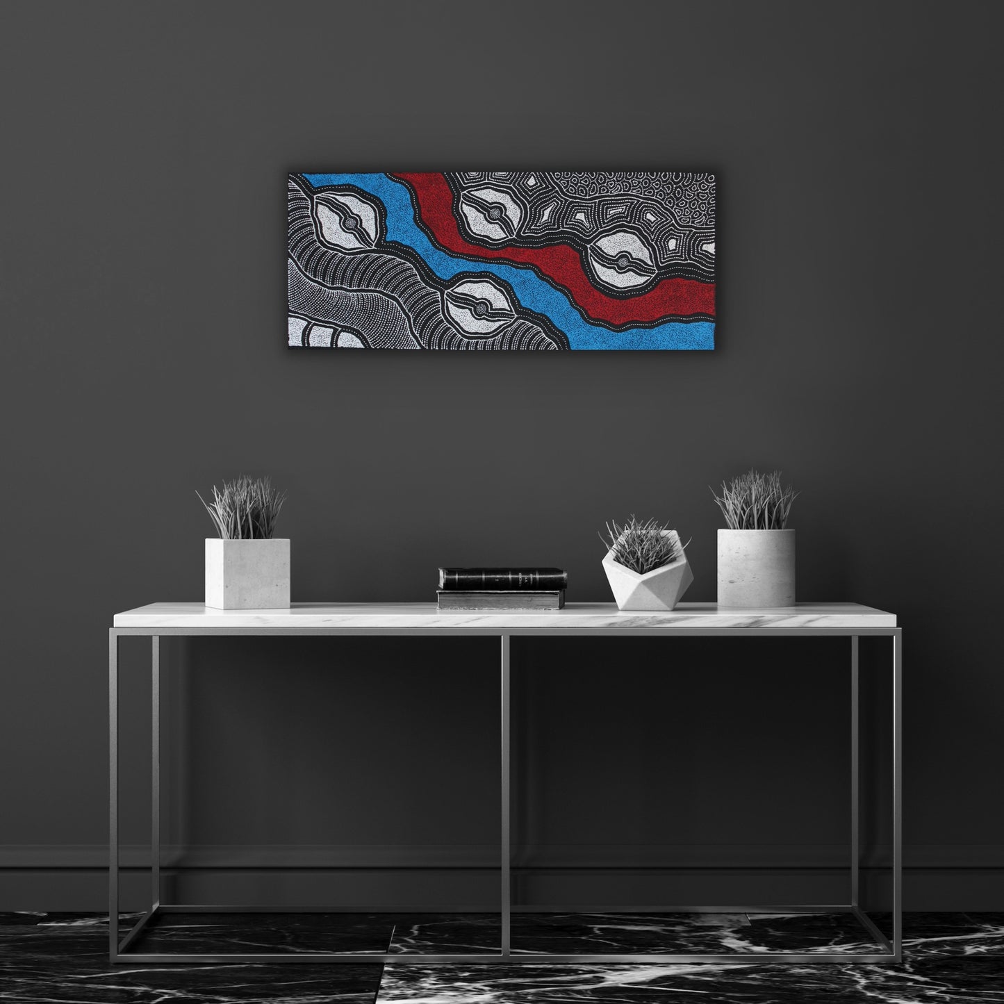 A painting by Delvine Pitjara, featuring intricate white dots and fine linework on a canvas with red and blue elements, representing aspects of Australian Aboriginal art.